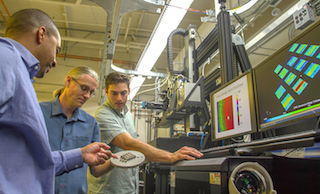 (L-r): LLNL researchers Ibo Matthews, Gabe Guss and Phil Depond examine a 3D-printed set of metal test cubes. Image credit: LLNL.