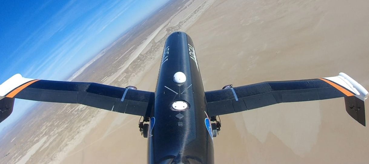 A view down the fuselage of the plane from a camera mounted at the top of the aircraft’s rudder showing the wings folded to their maximum extent downward. Source: NASA