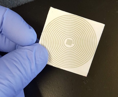 A printed, paper resonant sensor is being developed to detect COVID-19 RNA genetic material.  Source: Nigel Reuel/ Iowa State University