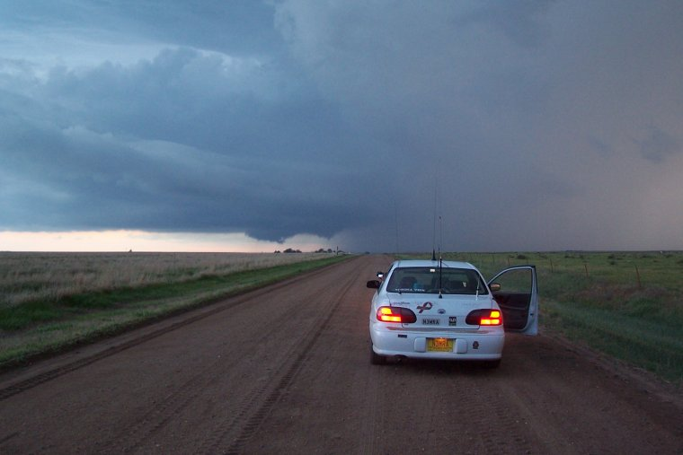 The author’s 2002 Chevrolet Malibu on a tornadic supercell near Quinter, KS, on May 25, 2010. Notice the antennas for amateur radio equipment.