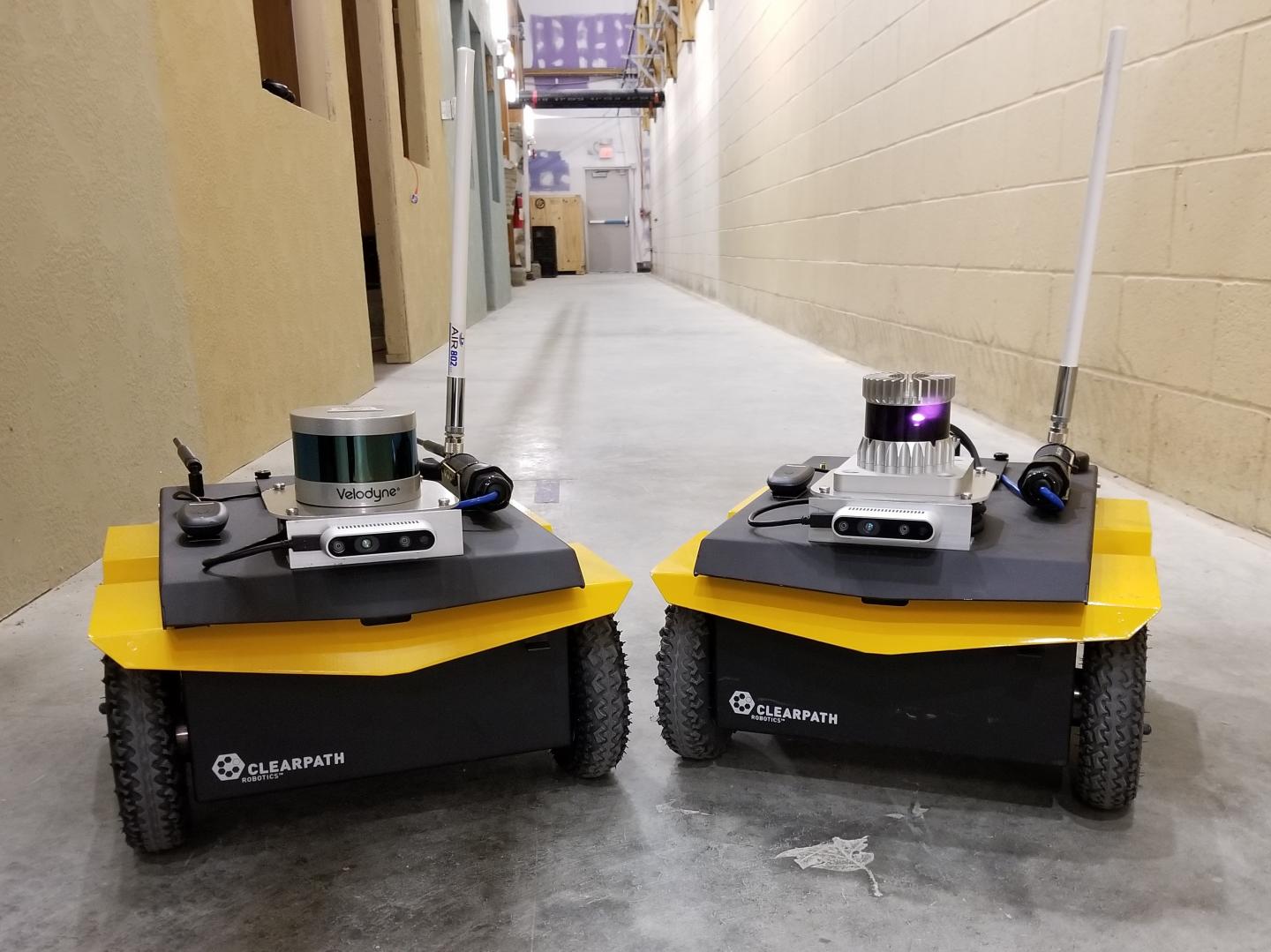 The two robots used in the experiments are identically equipped, with the exception of Velodyne VLP-16 lidar (left) and Ouster OS1 lidar (right). Source: U.S. Army