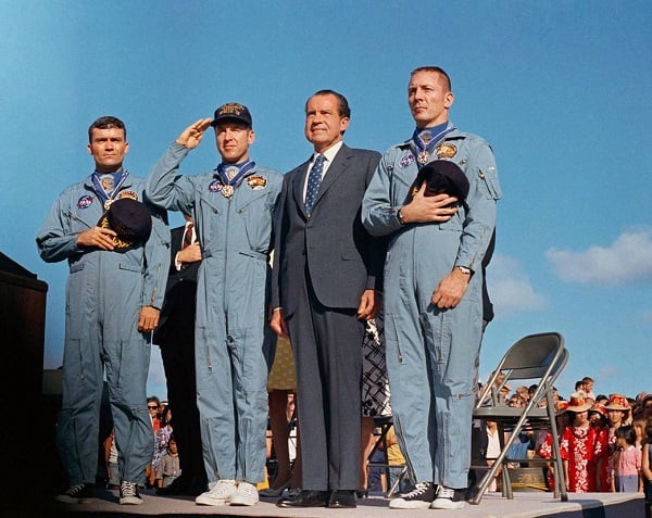 resident Richard M. Nixon and the Apollo 13 crew salute the U.S. flag during the post-mission ceremonies at Hickam Air Force Base, Hawaii. Earlier, the astronauts Fred Haise, Jim Lovell and Jack Swigert were presented the Presidential Medal of Freedom 