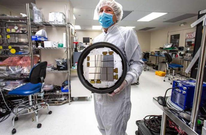 SLAC’s Chris Kenney holds a 16-module, 2.2-megapixel ePix10k X-ray camera. Source: Jacqueline Ramseyer Orrell/SLAC National Accelerator Laboratory