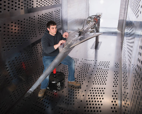 A NASA Glenn Research Center technician prepares the QueSST experimental aircraft for testing in the 8’ x 6’ wind tunnel. Image credit: NASA