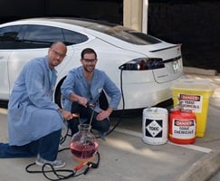 Scripps Research Institute chemists Phil Baran (left) and Evan Horn pose in front of an electric car, whose principles of sustainable transport pertain to the sustainable chemistry. Source: The Scripps Research Institute