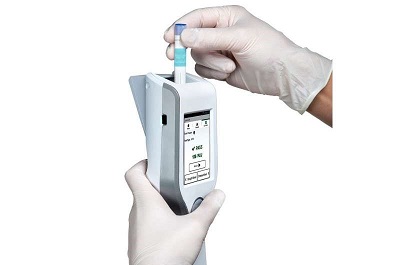A food safety professional uses the 3M Clean-Trace luminometer to read a swab. Source: Cornell University
