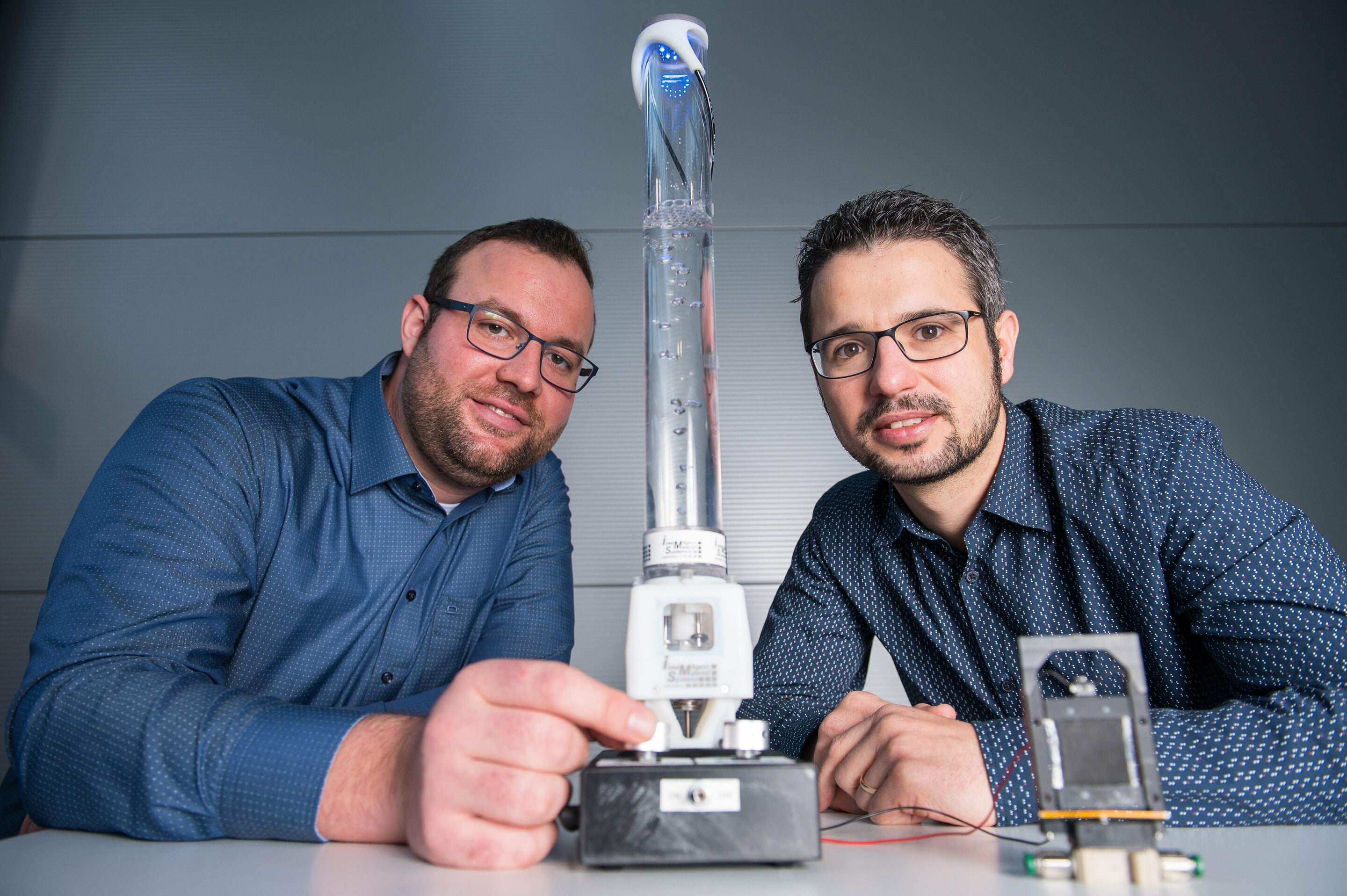 Saarland engineers with prototypes of a motorless pump (center) and a smart valve (front right) made from electroactive polymer film. Source: Oliver Dietze