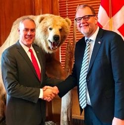 Interior Secretary Ryan Zinke and Danish Energy and Climate Minister Lars Christian Lilleholt with an unidentified grizzly bear. Source: Danish Climate and Energy Ministry