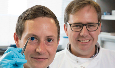 Researchers display a 3D-printed cornea. Source: Newcastle University