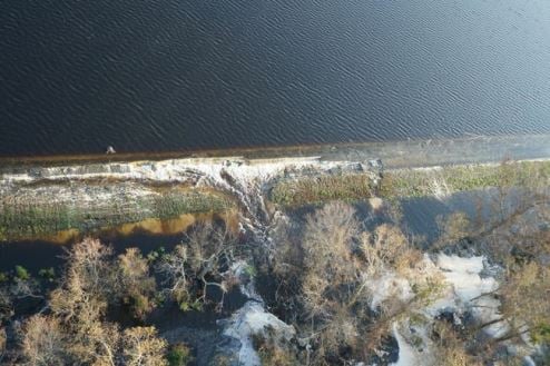 Duke Energy photo showing foam-like cenospheres leaving Lake Sutton and entering the Cape Fear River.