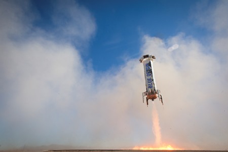 An engine on the Blue Origin booster stage fires at around 3,000 feet and helps to slow the vehicle as it returns to earth. Image source: Blue Origin.