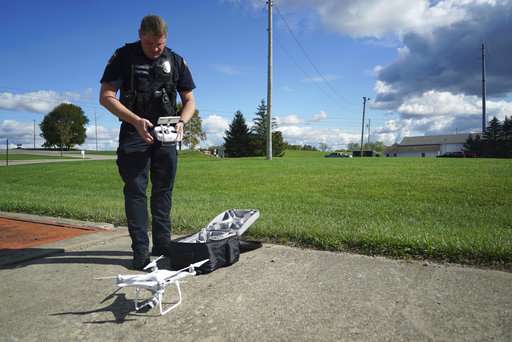 Streetsboro Officer Scott Hermon prepares to pilot the department's first drone in Streetsboro, Ohio. Streetsboro Police became one of hundreds of agencies across the country adopting drone technology when Hermon became the first Streetsboro officer certified to fly drones in October. Streetsboro Police say they can't afford a helicopter, but a drone provides many of the same capabilities at a fraction of the price. Source: AP Photo/Dake Kang